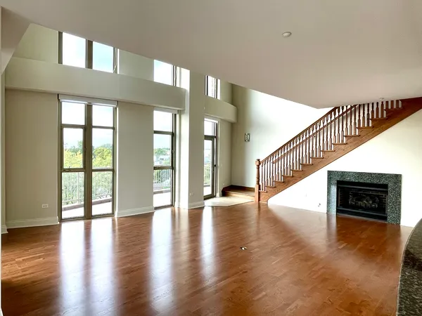 a view of an entryway with wooden floor and a living room