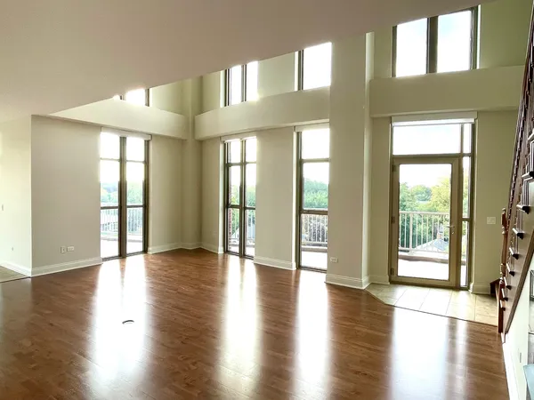 a view of an entryway with wooden floor and windows