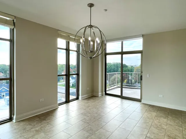 a view of an empty room with glass door and balcony