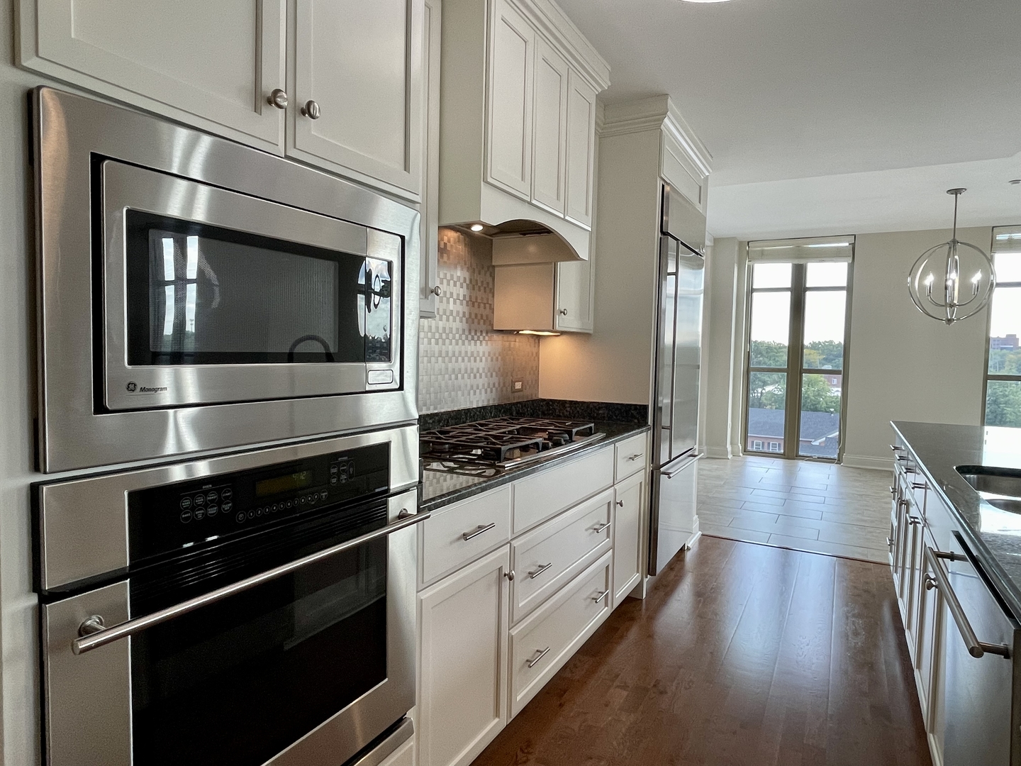 520 South Washington Street, Unit 604 Naperville, IL 60540 - Photo 10 of 32 a kitchen with stainless steel appliances and granite countertop wooden cabinets