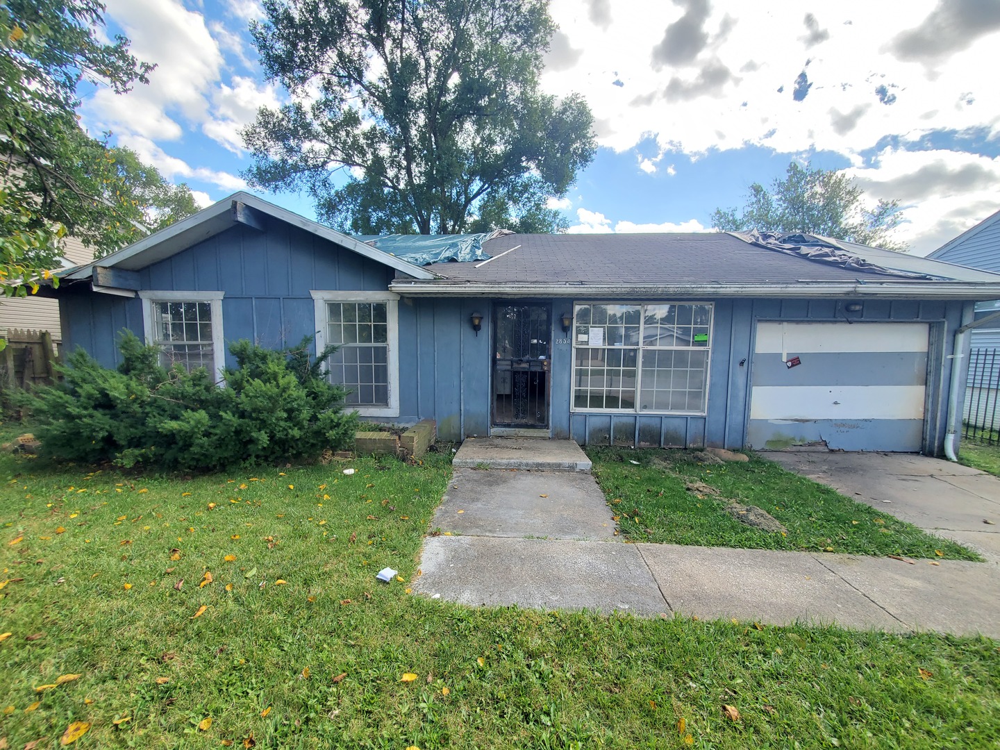 2854 223rd Street Sauk Village, IL 60411 - Photo 1 of 18 a front view of a house with a garden and trees