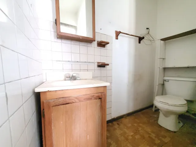 a bathroom with a sink toilet and a mirror