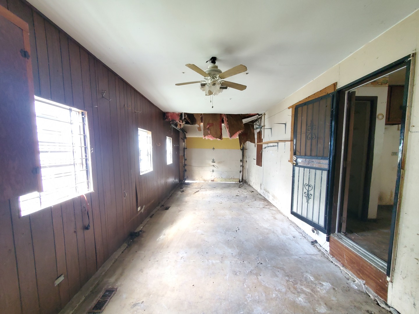 2854 223rd Street Sauk Village, IL 60411 - Photo 17 of 18 a view of a hallway with windows and refrigerator