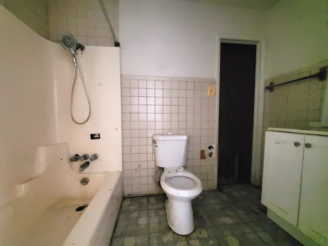 a bathroom with a toilet and a shower