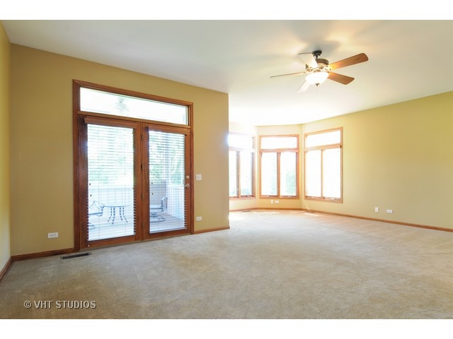 3737 Wolf Road Oswego, IL 60543 - Photo 16 of 25 a view of an empty room with chandelier fan and a large window