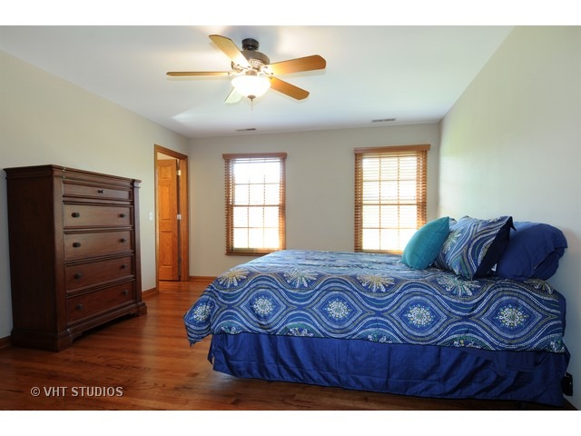 3737 Wolf Road Oswego, IL 60543 - Photo 19 of 25 a bedroom with a bed and a window