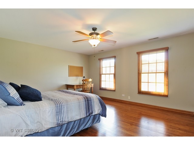 3737 Wolf Road Oswego, IL 60543 - Photo 20 of 25 a bedroom with a bed and wooden floor
