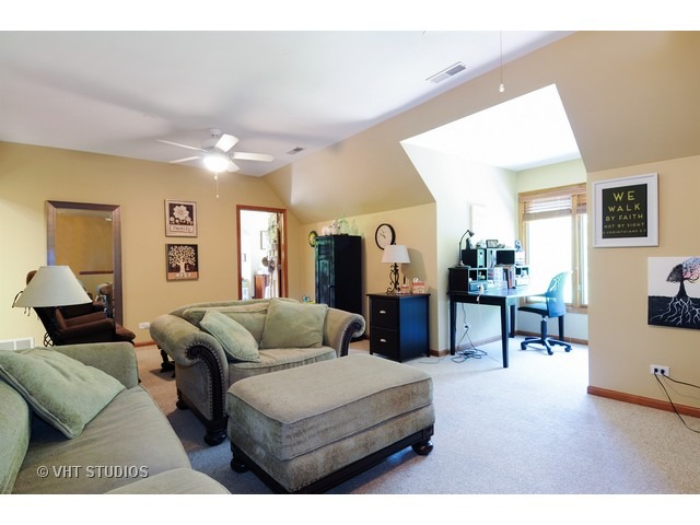 3737 Wolf Road Oswego, IL 60543 - Photo 25 of 25 a living room with furniture and a dining table