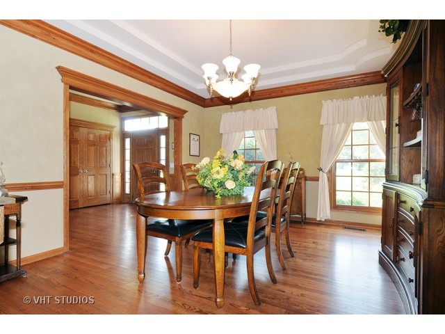 3737 Wolf Road Oswego, IL 60543 - Photo 8 of 25 a view of a dining room with furniture and wooden floor