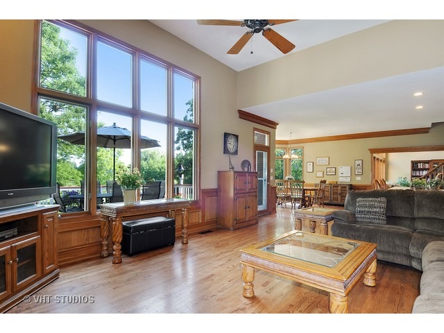 3737 Wolf Road Oswego, IL 60543 - Photo 9 of 25 a living room with furniture a flat screen tv and a large window