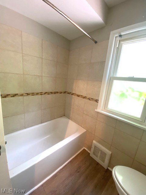 4230 Bluestone Road South Euclid, OH 44121 - Photo 14 of 35 Bathroom featuring a healthy amount of sunlight, toilet, hardwood flooring, and shower / bathtub combination