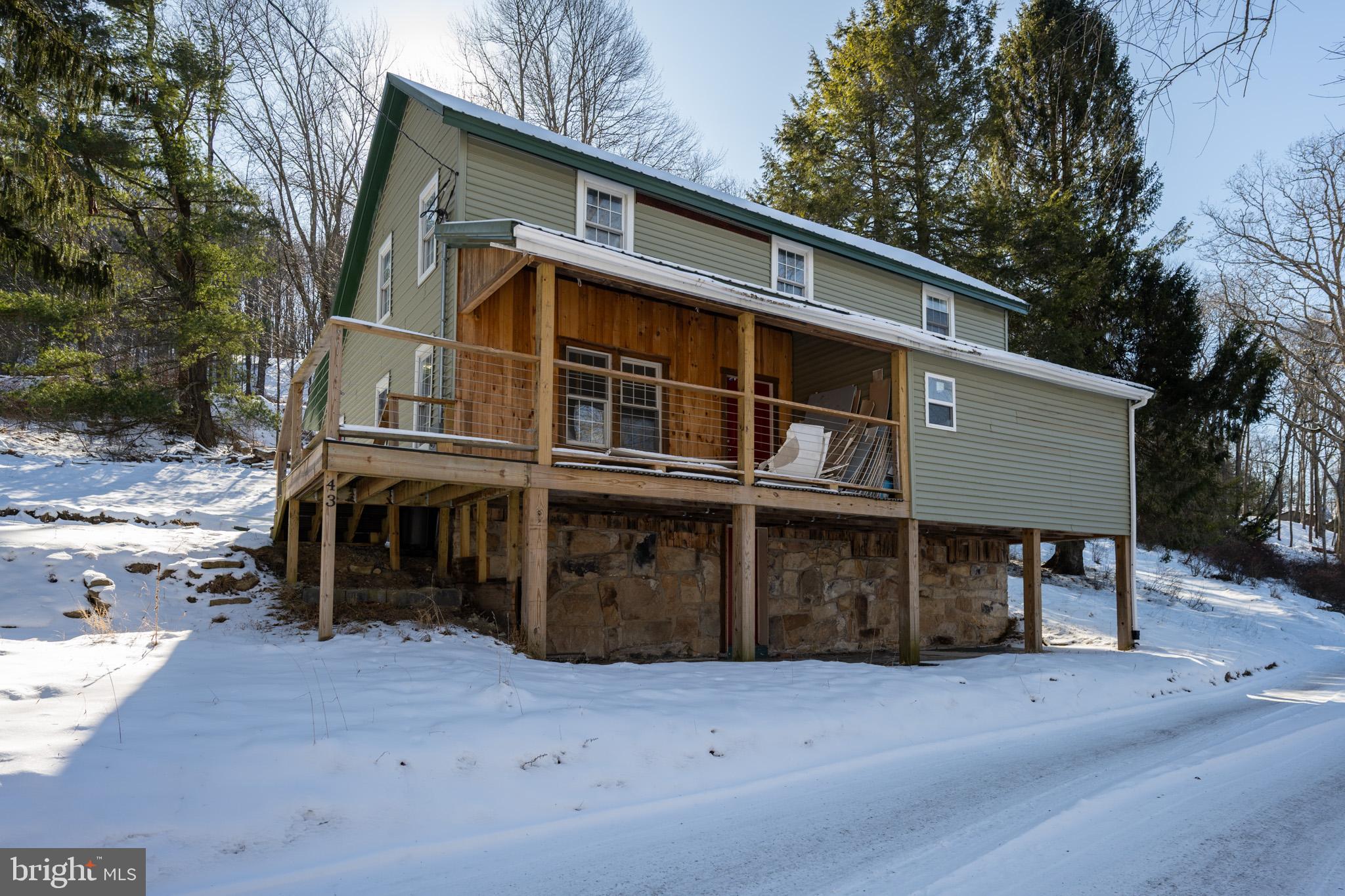 43 Sloan Tract Road Oakland, MD 21550 - Photo 2 of 47 Charming hillside retreat in winter's embrace.