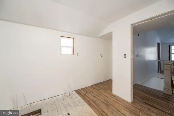 a view of a hallway view with wooden floor and staircase