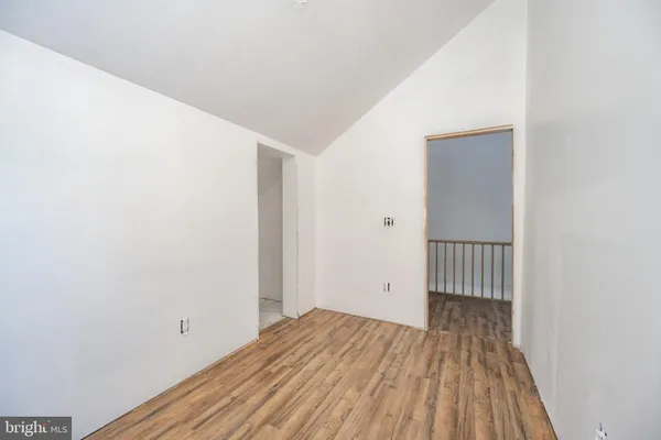 a view of a room with wooden floor