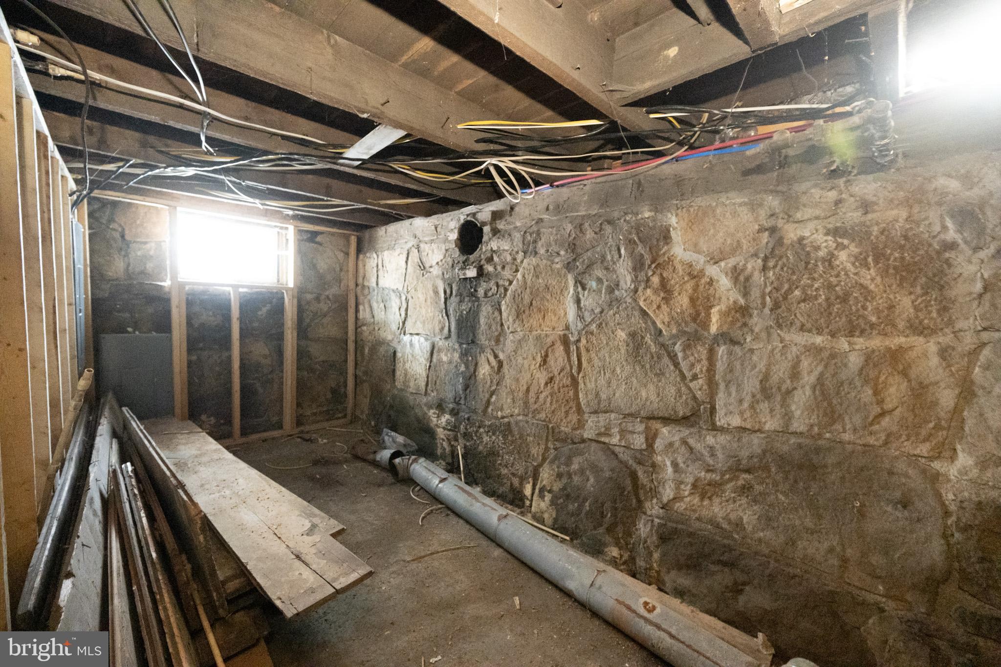 43 Sloan Tract Road Oakland, MD 21550 - Photo 43 of 47 Exposed stone walls in a raw space.