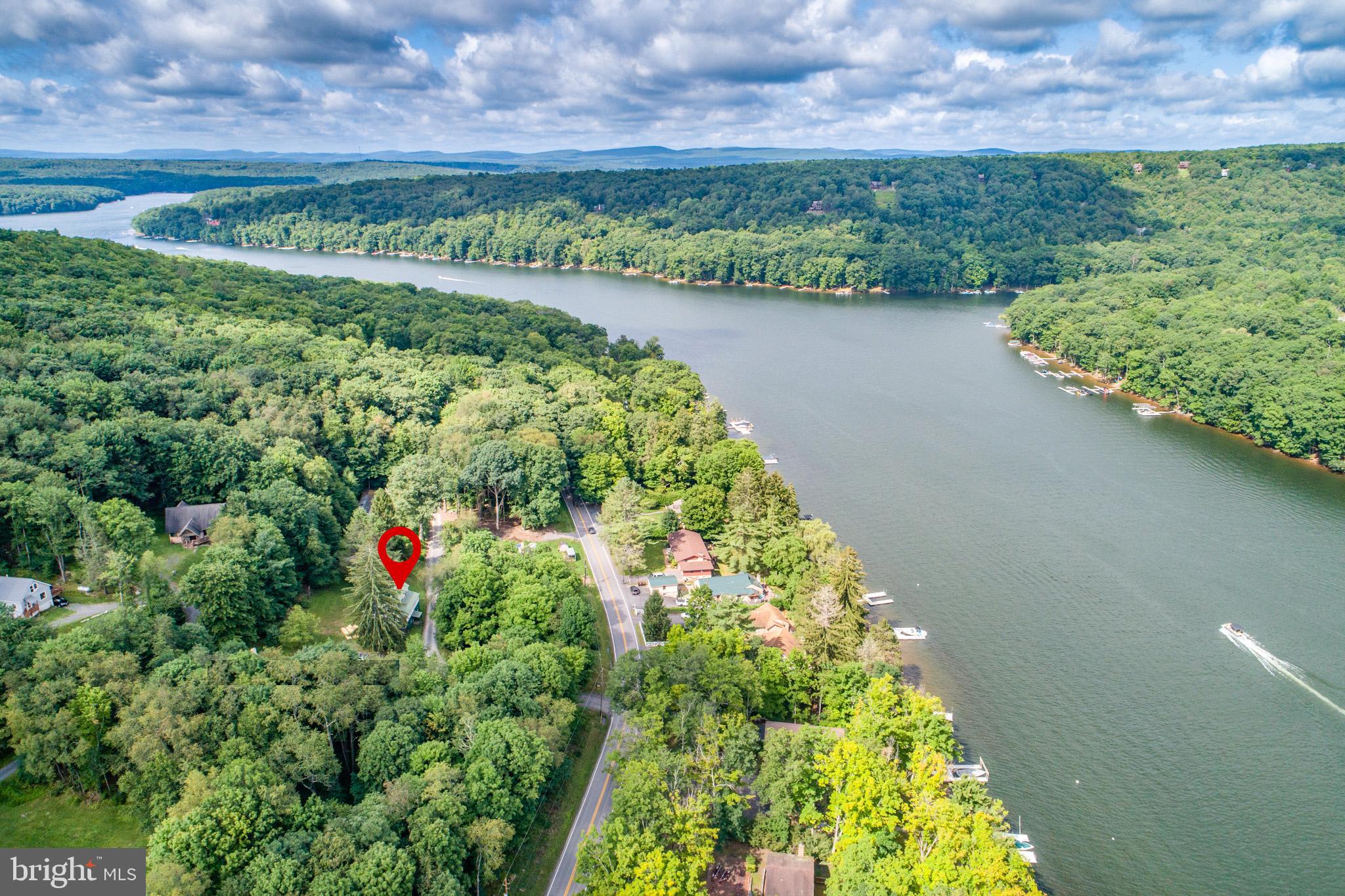 43 Sloan Tract Road Oakland, MD 21550 - Photo 45 of 47 Serene riverside retreat amidst lush greenery.