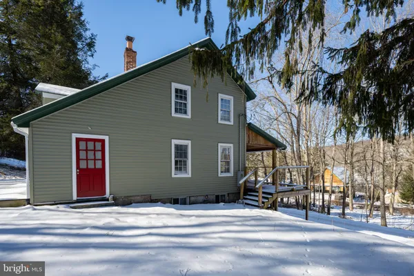 a house that has a tree in front of it