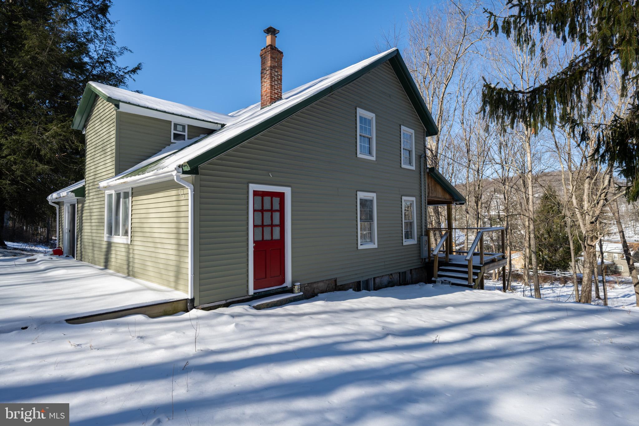 43 Sloan Tract Road Oakland, MD 21550 - Photo 6 of 47 Charming home nestled in a snowy landscape.