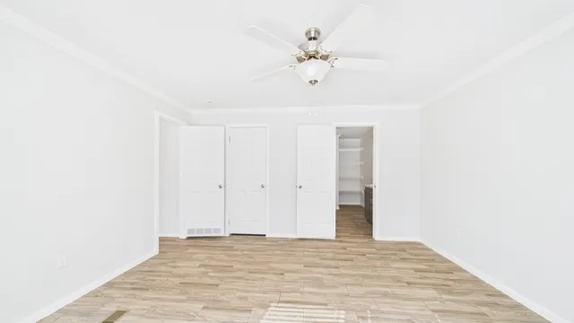 a view of an empty room with wooden floor
