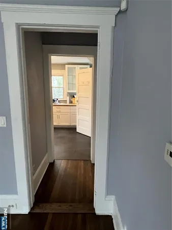 a view of hallway with wooden floor