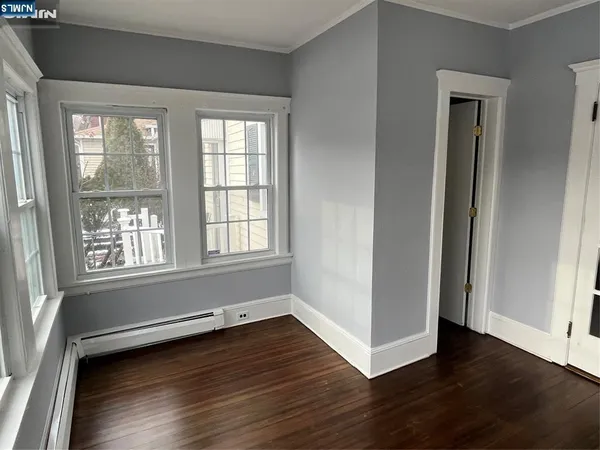 a view of a livingroom with wooden floor and a window