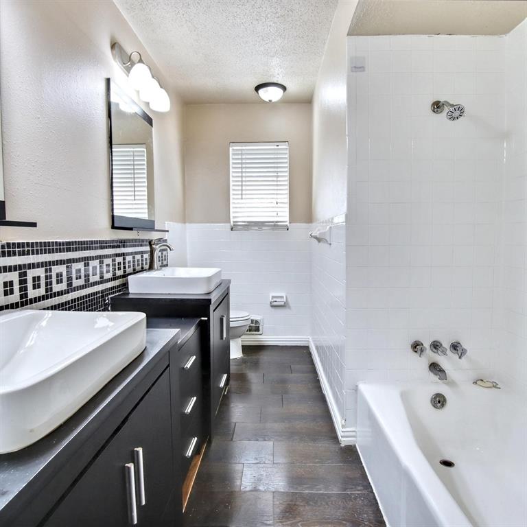 9914-9916 Brockbank Drive Dallas, TX 75220 - Photo 10 of 12 a bathroom with a tub sink and mirror