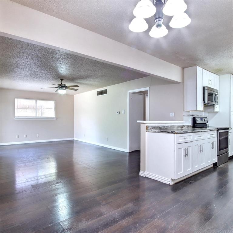 9914-9916 Brockbank Drive Dallas, TX 75220 - Photo 12 of 12 a large white kitchen with cabinets