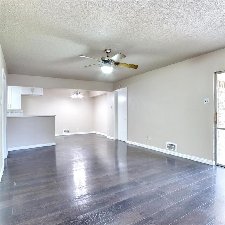 9914-9916 Brockbank Drive Dallas, TX 75220 - Photo 3 of 12 a view of an empty room with a window and wooden floor