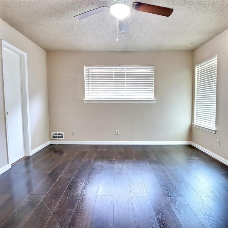 9914-9916 Brockbank Drive Dallas, TX 75220 - Photo 9 of 12 an empty room with wooden floor and windows