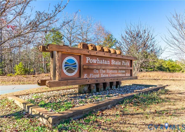 a view of a street sign under a large tree