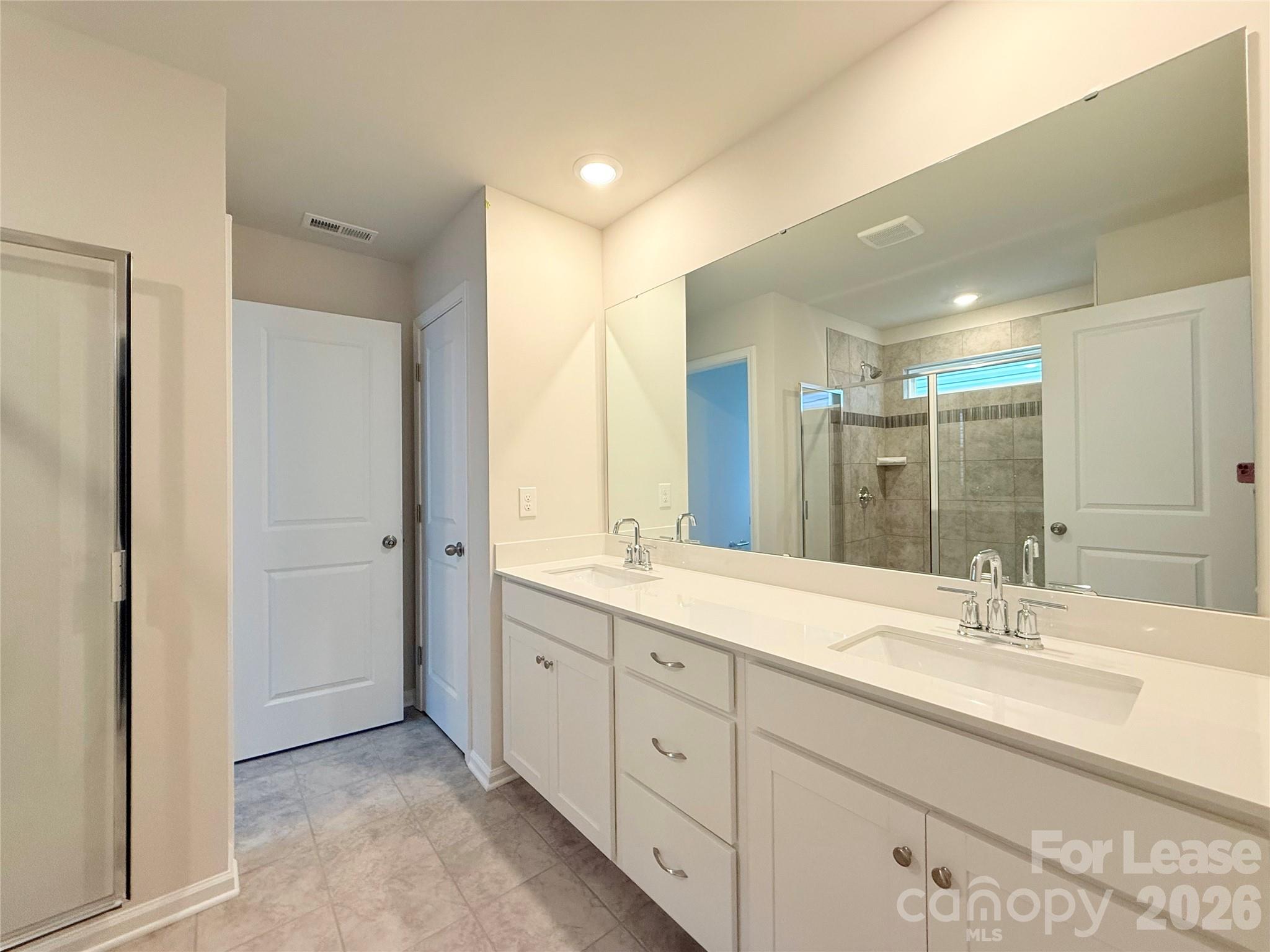 4345 Shimmering Stone Way Maiden, NC 28650 - Photo 16 of 27 a spacious bathroom with a double vanity sink mirror and double