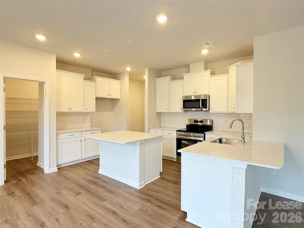 a kitchen with a sink stainless steel appliances and cabinets
