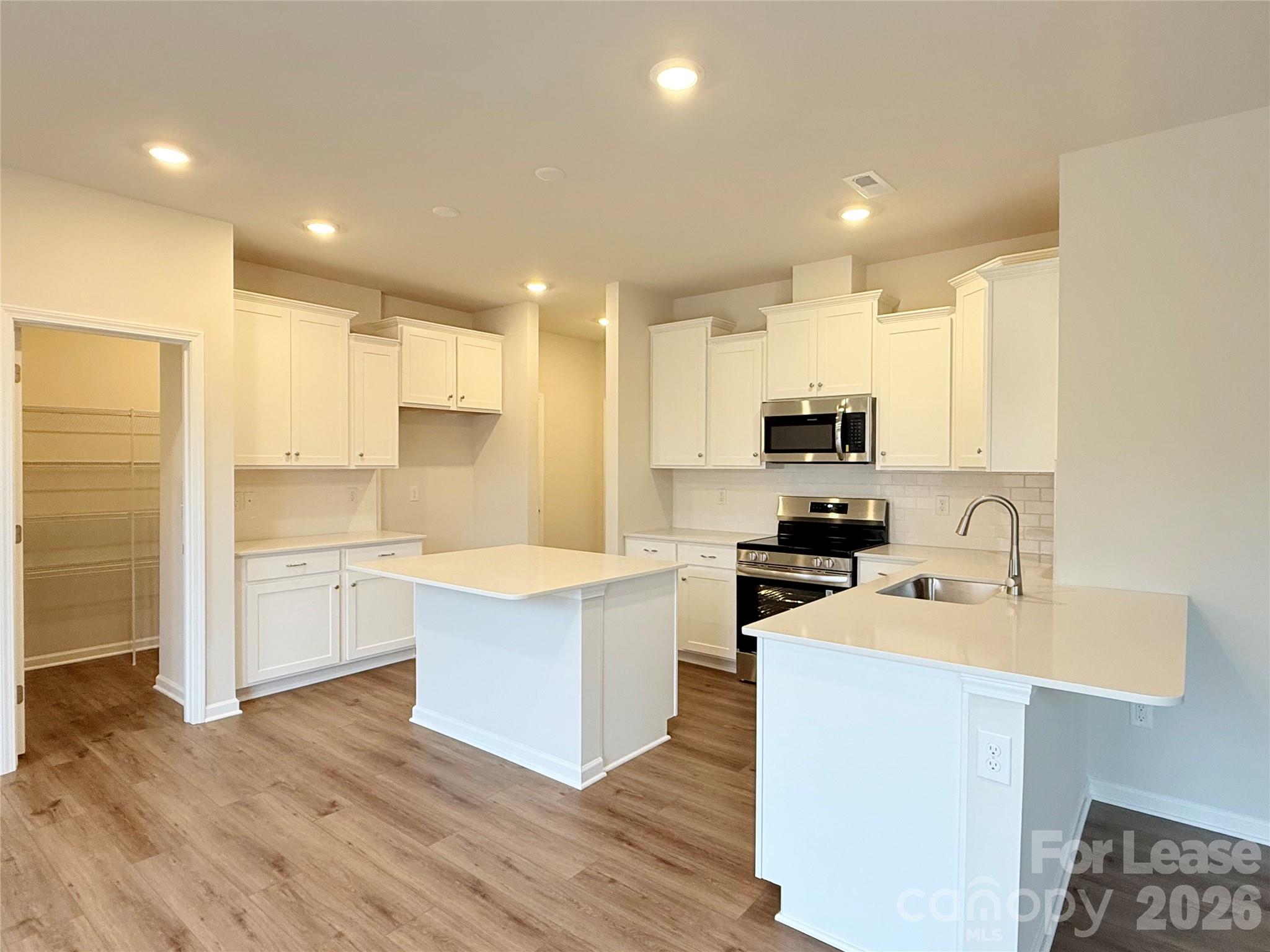 4345 Shimmering Stone Way Maiden, NC 28650 - Photo 8 of 27 a kitchen with a sink stainless steel appliances and cabinets