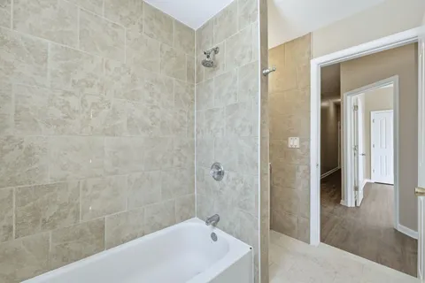 a bathroom with a bathtub and shower