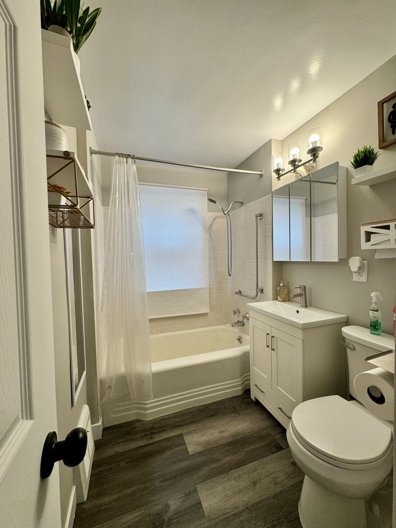 11042 South State Line Road Chicago, IL 60617 - Photo 5 of 12 a bathroom with a sink a toilet and shower