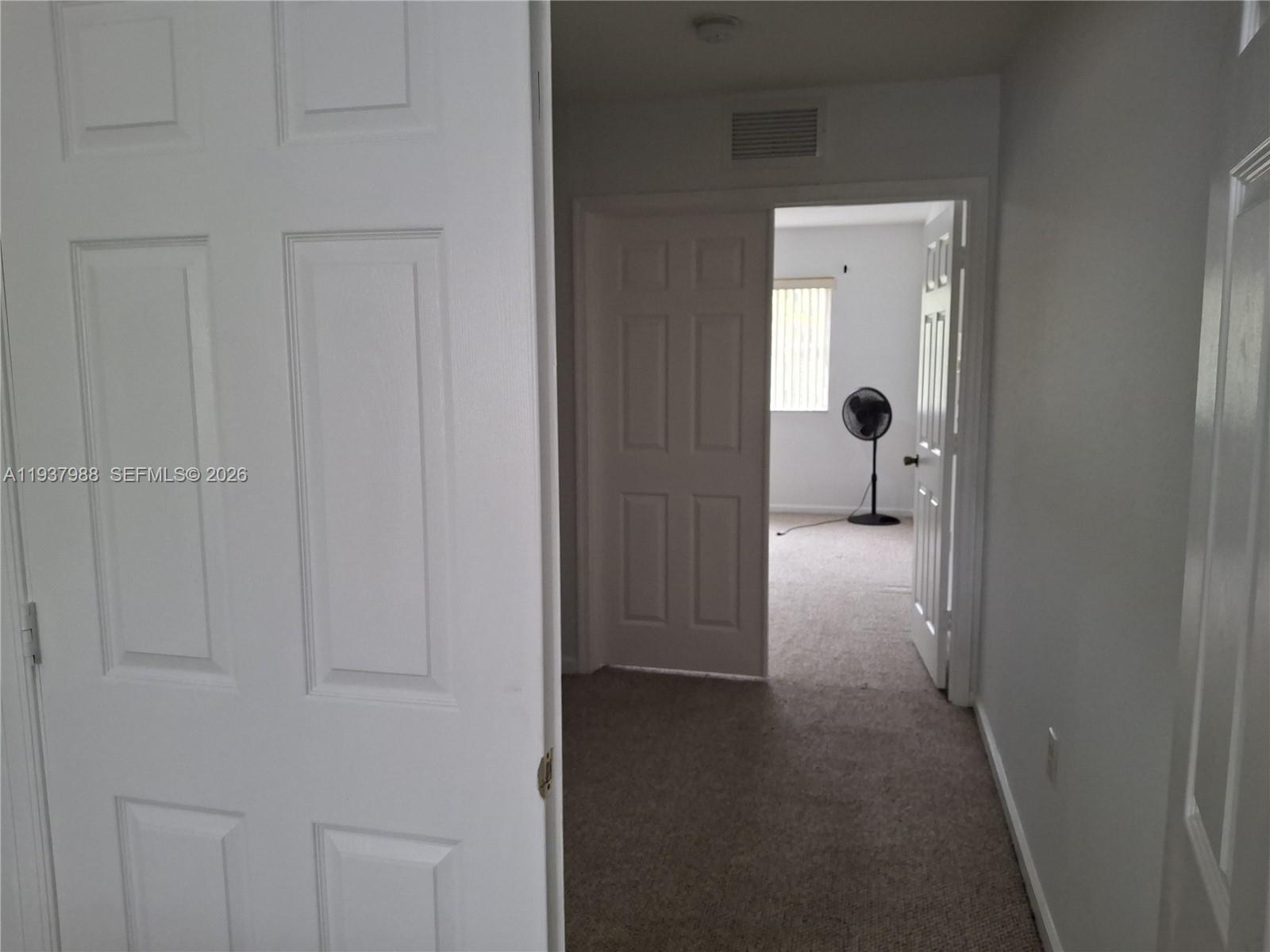 8372 Southwest 25th Court, Unit 102 Miramar, FL 33025 - Photo 11 of 11 a view of a hallway with wooden floor and a cabinet
