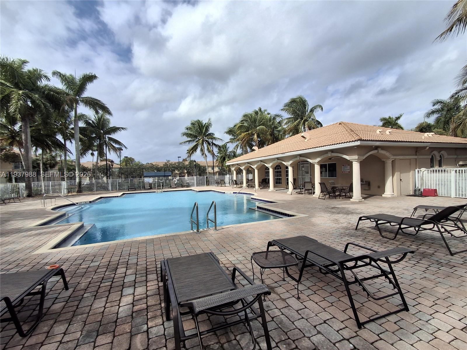 8372 Southwest 25th Court, Unit 102 Miramar, FL 33025 - Photo 3 of 11 a view of a house with pool and sitting area