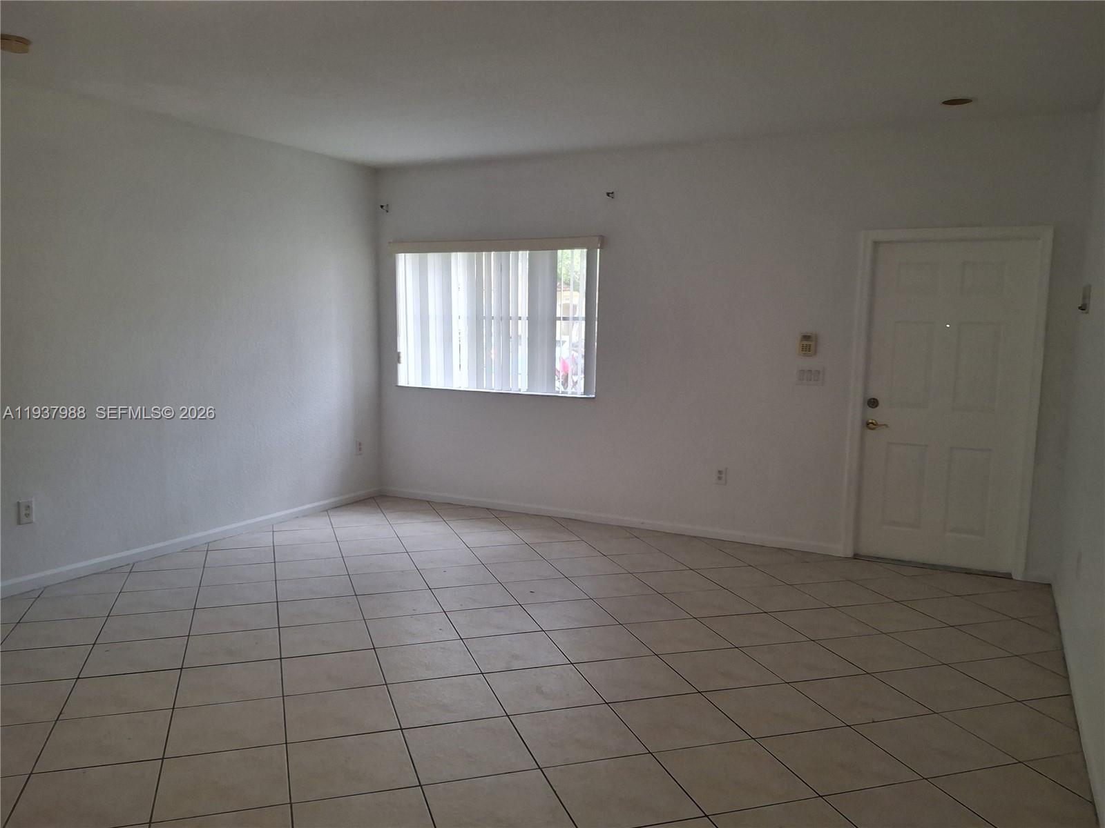 8372 Southwest 25th Court, Unit 102 Miramar, FL 33025 - Photo 7 of 11 an empty room with windows