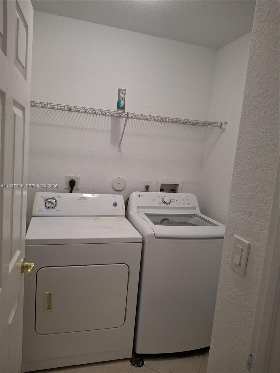 8372 Southwest 25th Court, Unit 102 Miramar, FL 33025 - Photo 8 of 11 a utility room with dryer and washer