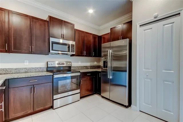 a kitchen with granite countertop a sink and cabinets