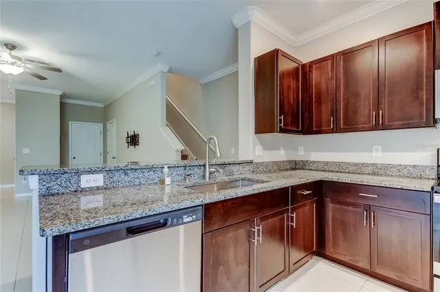 a kitchen with granite countertop a stove and a microwave with wooden cabinets