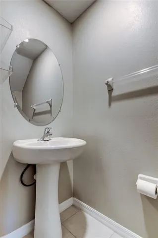 a bathroom with a granite countertop sink and a toilet