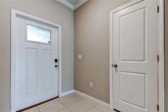 a view of kitchen with cabinets and window