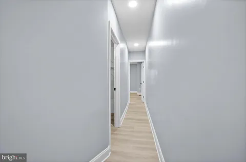 a view of a hallway with wooden floor