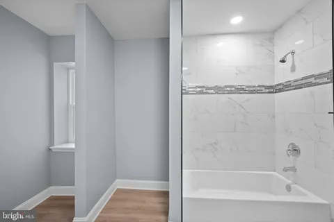 a bathroom with a bathtub and a shower