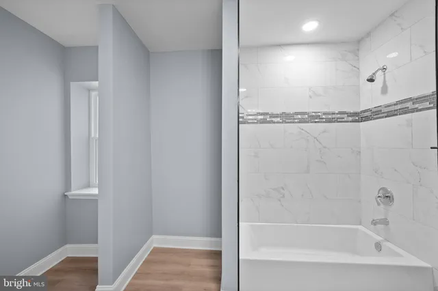 a bathroom with a bathtub and a shower