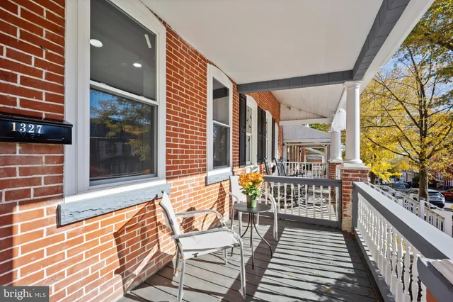 a balcony with furniture and wooden floor