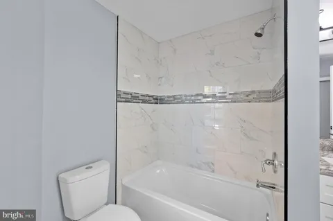 a bathroom with a shower and toilet