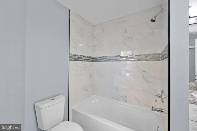 a bathroom with a shower and toilet