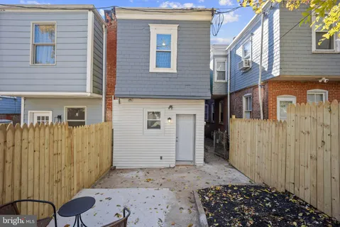 a view of a house with a wooden fence